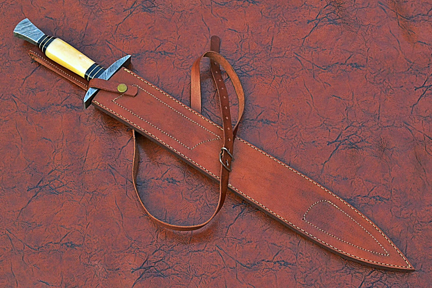 27" Long Sting Sword, 19" Long Hand Forged Damascus Steel Double Edge Blade with Triple Blood Groove, Brass Cross hilt Forward and Pommel, Damascus Guard & Pommel, Camel Bone Grip, Leather Scabbard