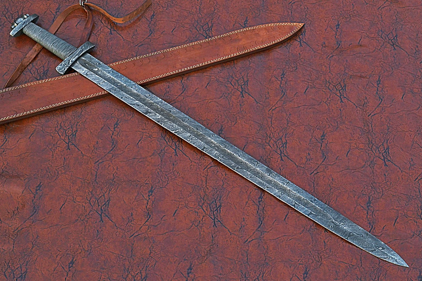 38 inches long Gladius sword, 31" long Hand forged Damascus steel double edge blade, Solid Damascus steel cross guard and pommel, Matching color thread wrap grip, Leather scabbard with shoulder stripe