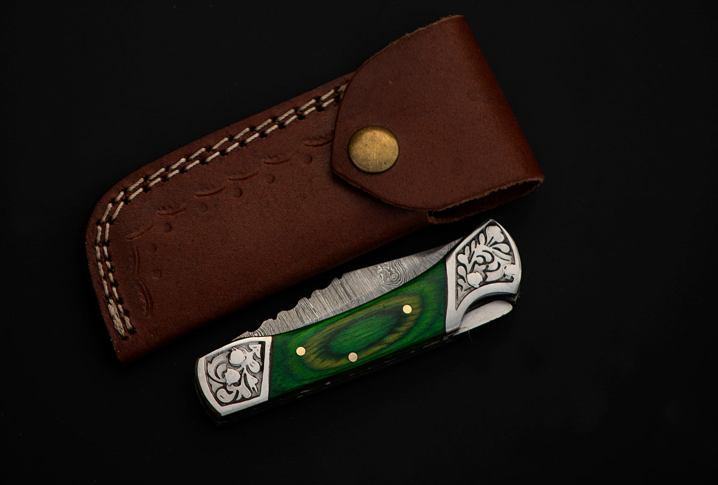 7" long back lock Folding Knife, Green colored wood Scale with Engraved steel bolster, custom made 3.25" Hand Forged Damascus steel blade, Cow hide leather sheath with belt loop