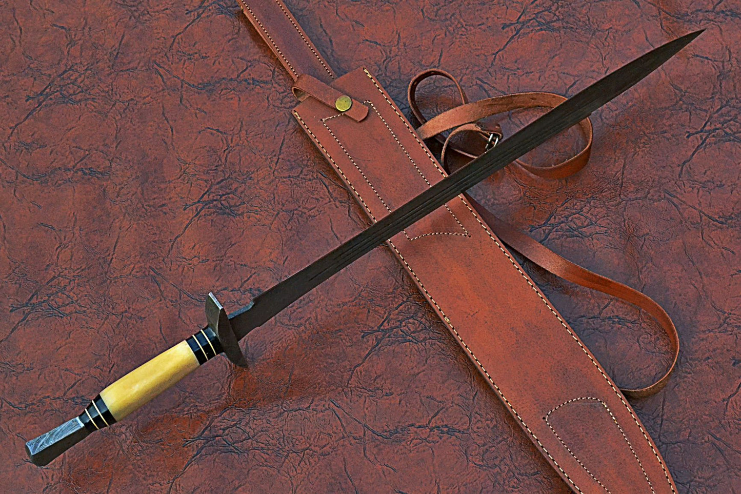 27" Long Sting Sword, 19" Long Hand Forged Damascus Steel Double Edge Blade with Triple Blood Groove, Brass Cross hilt Forward and Pommel, Damascus Guard & Pommel, Camel Bone Grip, Leather Scabbard
