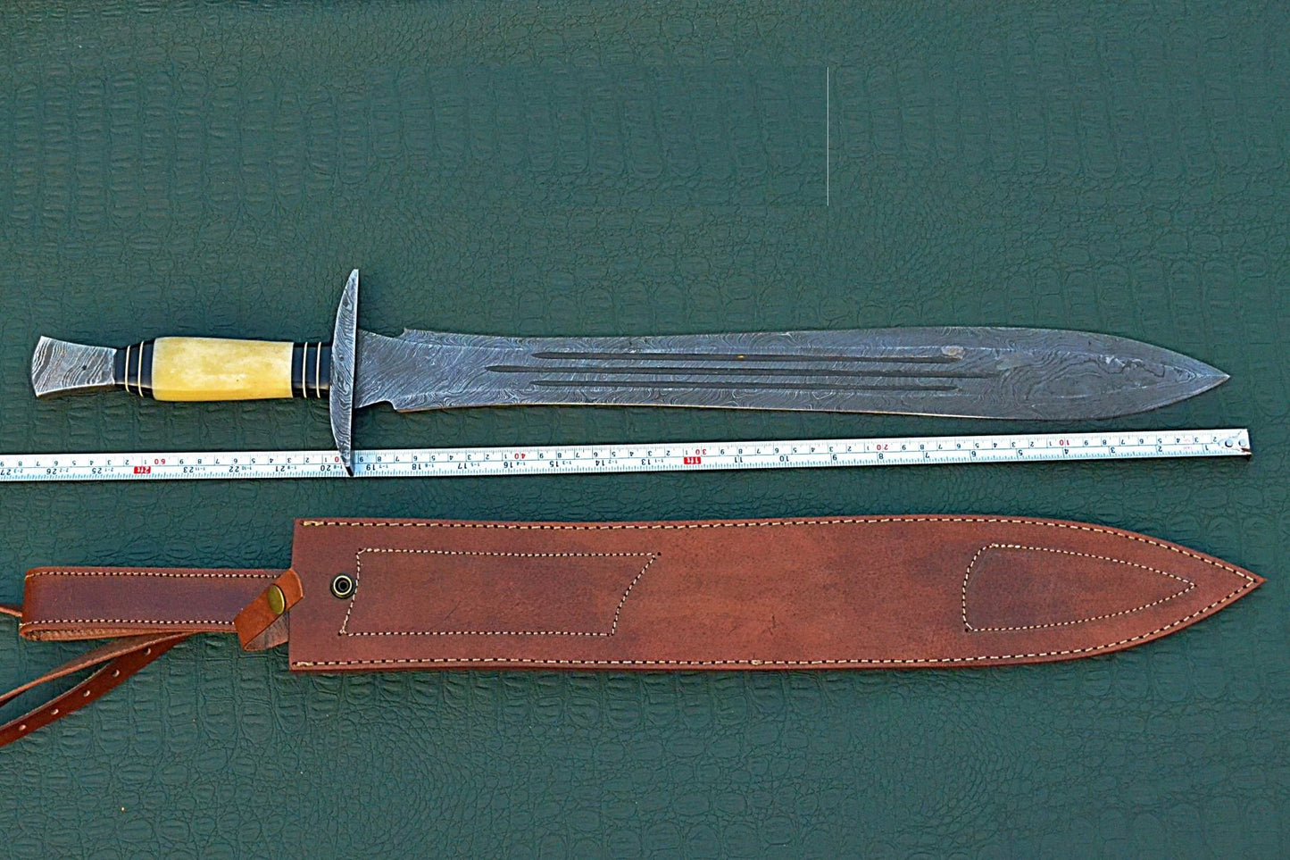 27" Long Sting Sword, 19" Long Hand Forged Damascus Steel Double Edge Blade with Triple Blood Groove, Brass Cross hilt Forward and Pommel, Damascus Guard & Pommel, Camel Bone Grip, Leather Scabbard