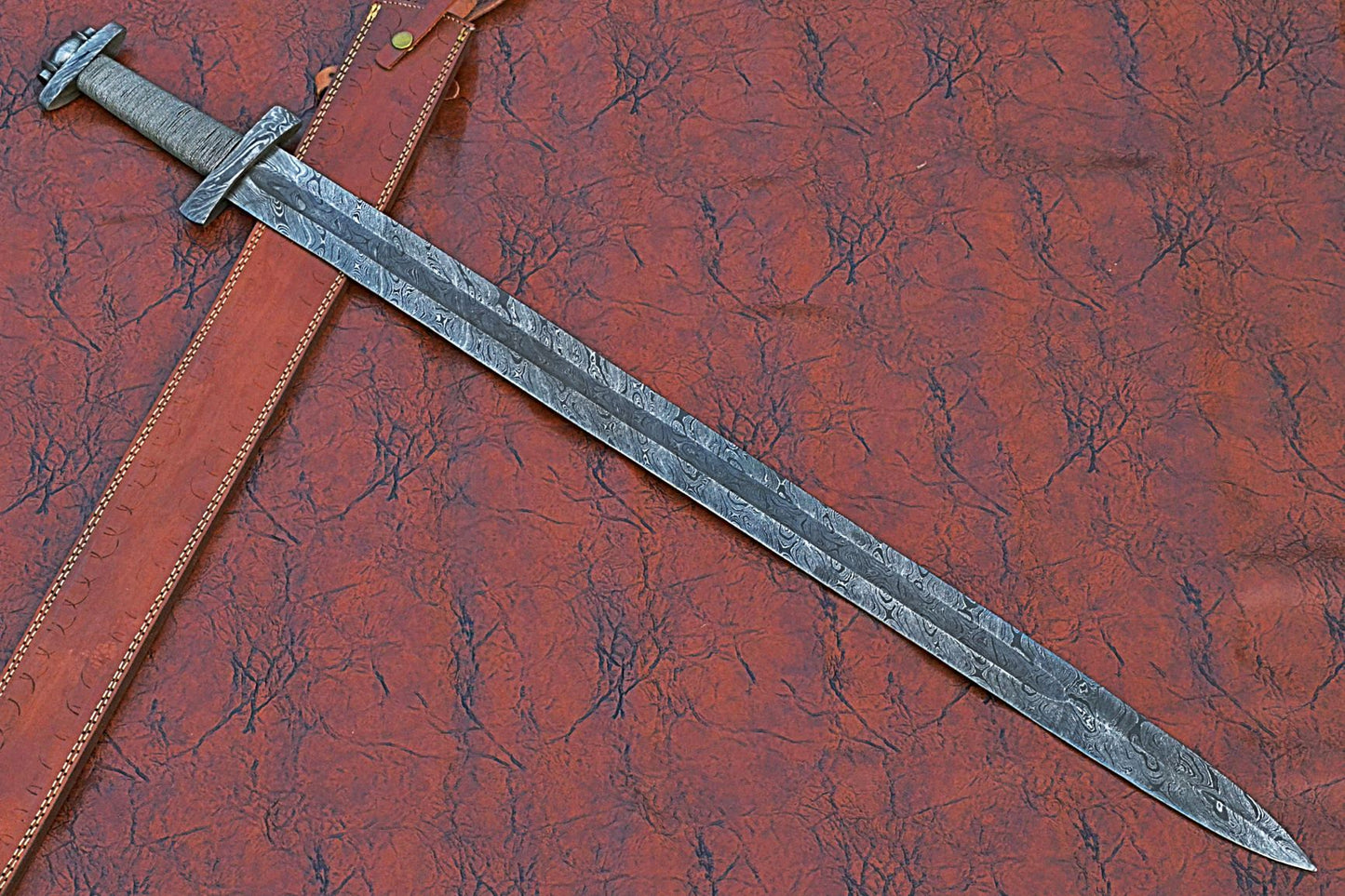 38 inches long Gladius sword, 31" long Hand forged Damascus steel double edge blade, Solid Damascus steel cross guard and pommel, Matching color thread wrap grip, Leather scabbard with shoulder stripe