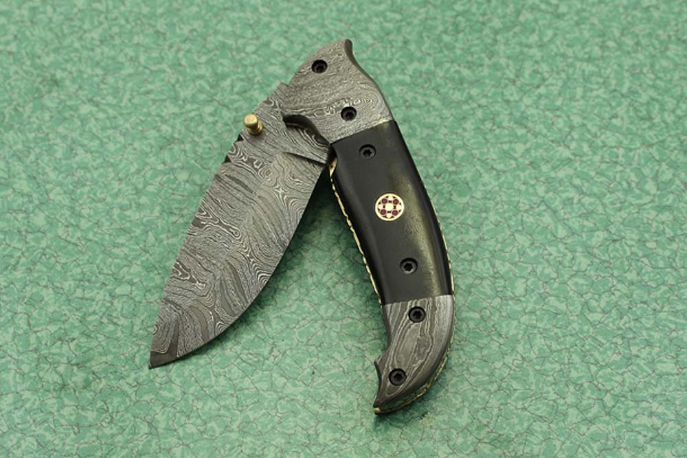 8 Inch Damascus steel folding knife, Available in Bone, Bull horn and Ram scales with Damascus bolster, Equipped with Thumb closing knob and liner lock, Cow hide Leather sheath with belt loop