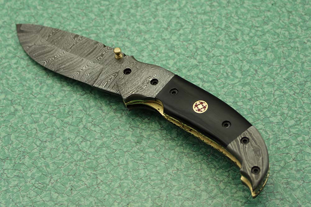 8 Inch Damascus steel folding knife, Available in Bone, Bull horn and Ram scales with Damascus bolster, Equipped with Thumb closing knob and liner lock, Cow hide Leather sheath with belt loop