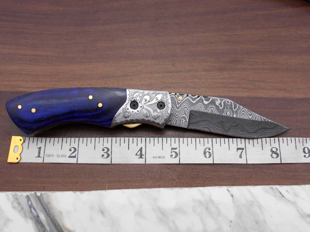 8" long hand forged custom made Damascus steel pocket clip folding knife, Blue Colored wood scale with engraved steel Bolster, Cow hide leather sheath included