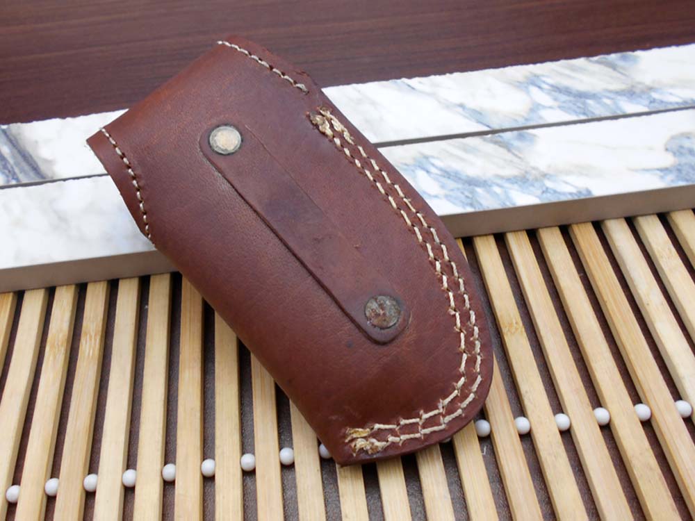 7.5" Damascus folding knife with Damascus bolster on both edges with thumb knob & liner lock equipped, Available in 4 scales, Cow hide leather sheath with belt loop included