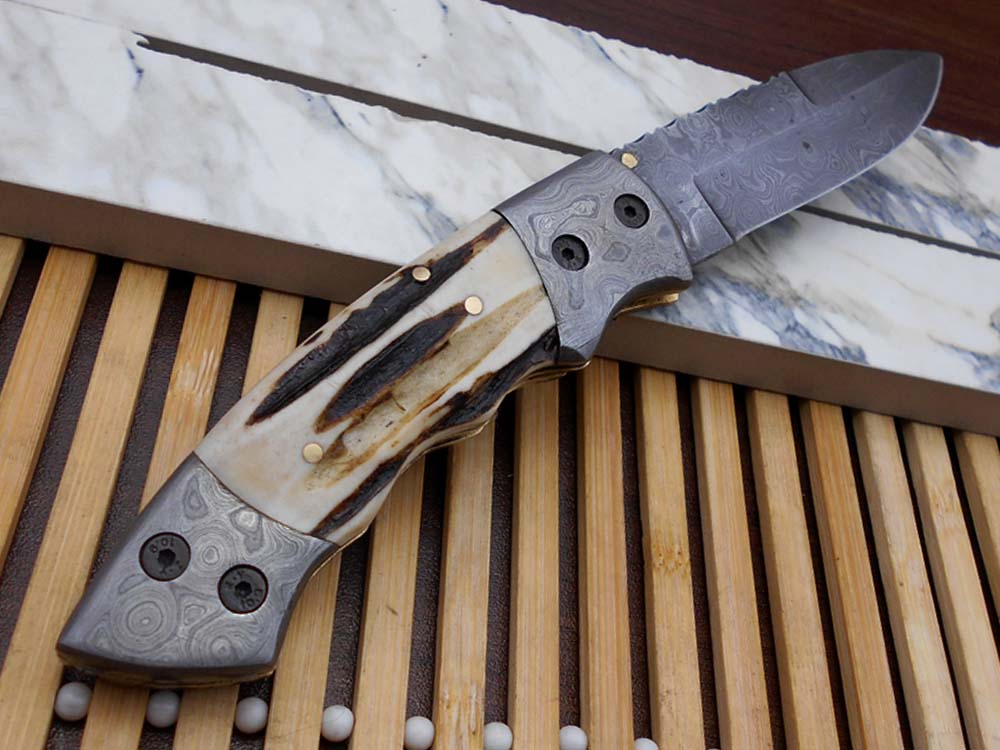 7.5" Damascus folding knife with Damascus bolster on both edges with thumb knob & liner lock equipped, Available in 4 scales, Cow hide leather sheath with belt loop included