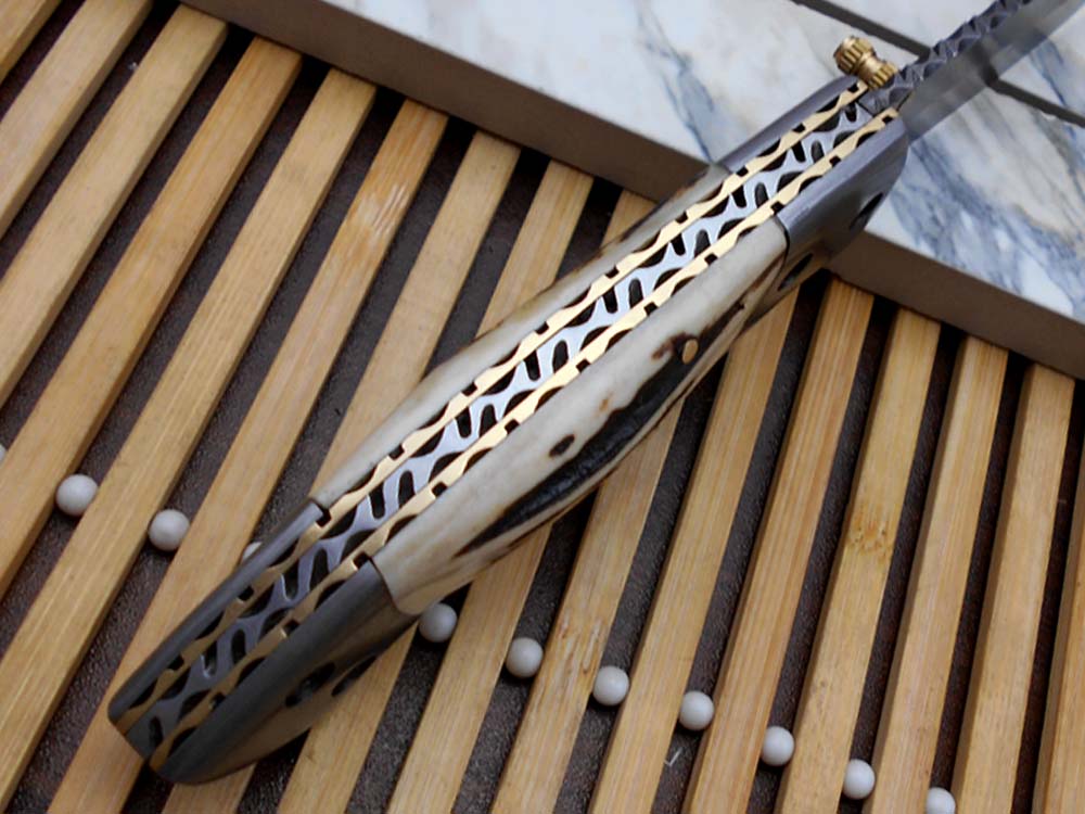 7.5" Damascus folding knife with Damascus bolster on both edges with thumb knob & liner lock equipped, Available in 4 scales, Cow hide leather sheath with belt loop included