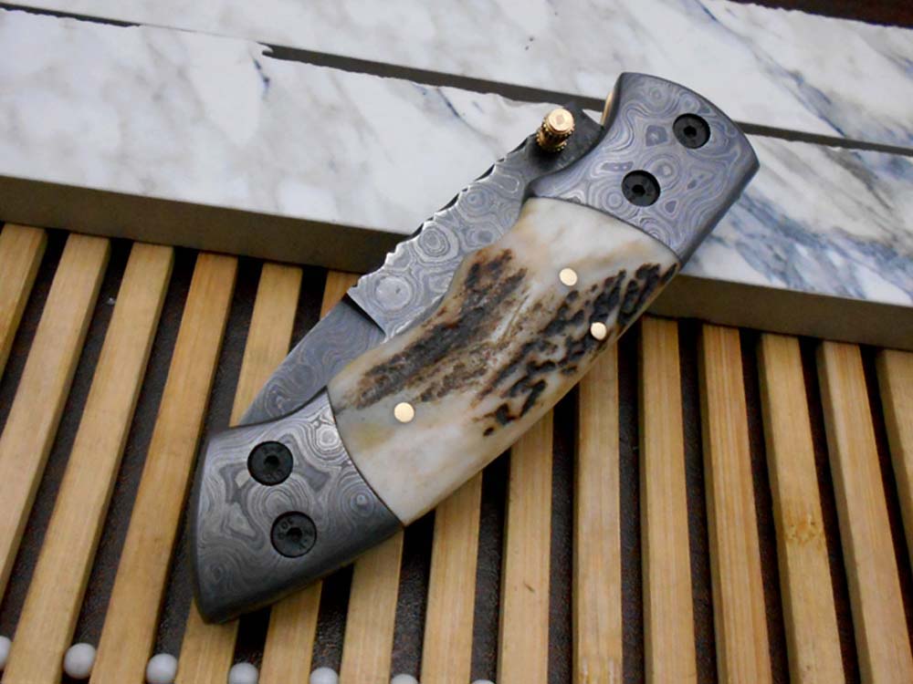 7.5" Damascus folding knife with Damascus bolster on both edges with thumb knob & liner lock equipped, Available in 4 scales, Cow hide leather sheath with belt loop included
