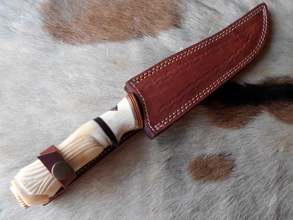 13 " long Damascus steel skinning knife, exotic hand carved Camel bone scale crafted with engraved brass, spacer and sliced bull horn, Cow hide leather sheath included.