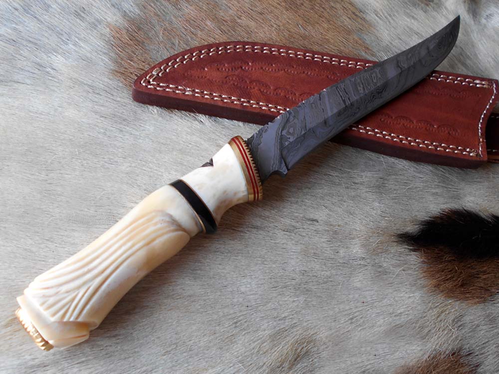 13 " long Damascus steel skinning knife, exotic hand carved Camel bone scale crafted with engraved brass, spacer and sliced bull horn, Cow hide leather sheath included.