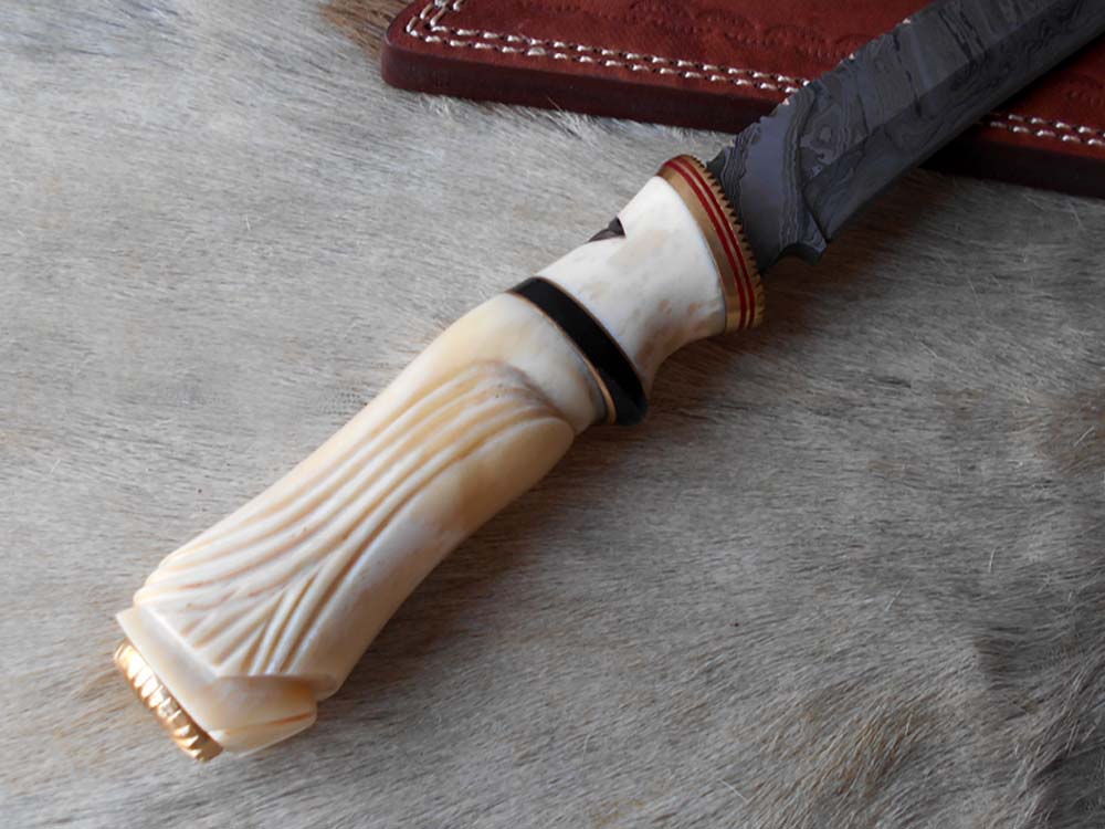 13 " long Damascus steel skinning knife, exotic hand carved Camel bone scale crafted with engraved brass, spacer and sliced bull horn, Cow hide leather sheath included.