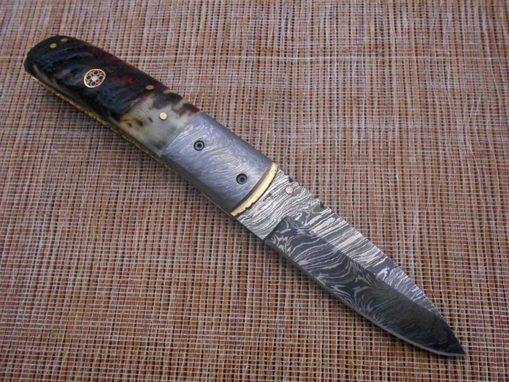 7.75" Damascus steel folding knife, liner lock, thumb knob, Cow sheath