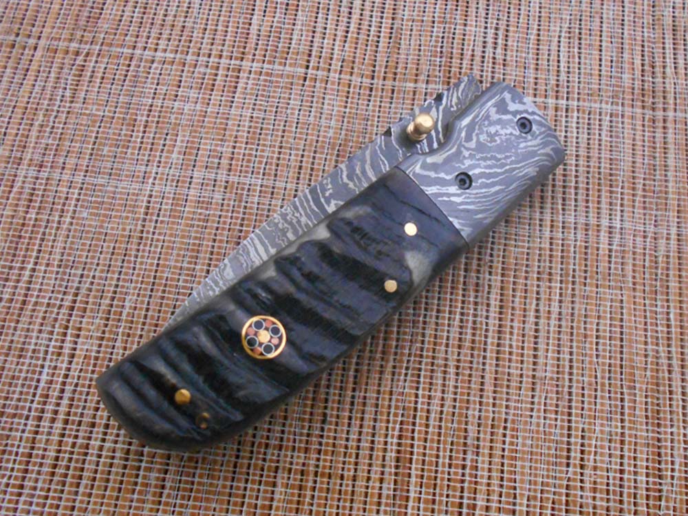 7.75" Damascus steel folding knife, liner lock, thumb knob, Cow sheath