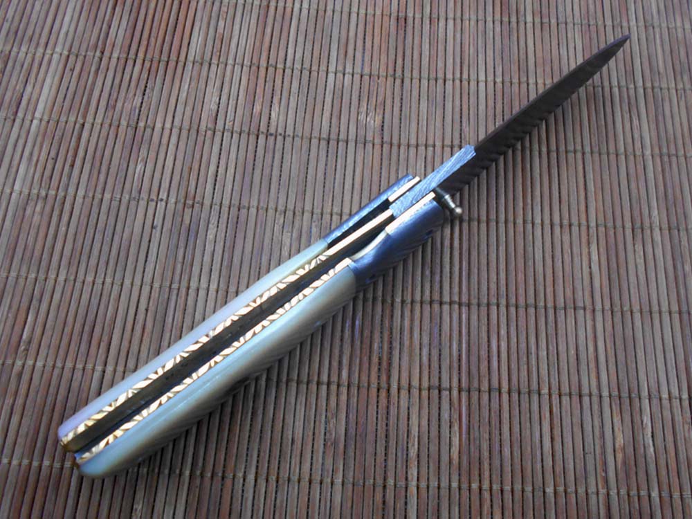 7.75" Damascus steel folding knife, liner lock, thumb knob, Cow sheath