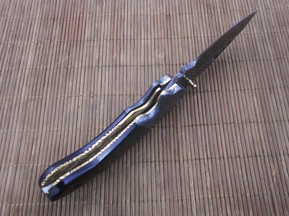 7.5" Folding Knife, 3.5" Hand Forged Twist Pattern Damascus Steel Blade with 3 Holes, Available in 3 Scale colors Pocket Knife, Liner Lock & Thumb knob Equipped, Cow Hide Leather Sheath included