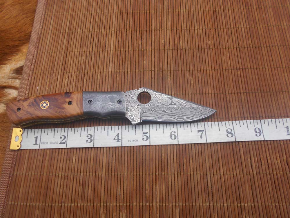 7.5" flat scale folding knife, Damascus steel blade with finger hole, Equipped with liner lock, Available in Wood & Horn scales, Leather sheath included