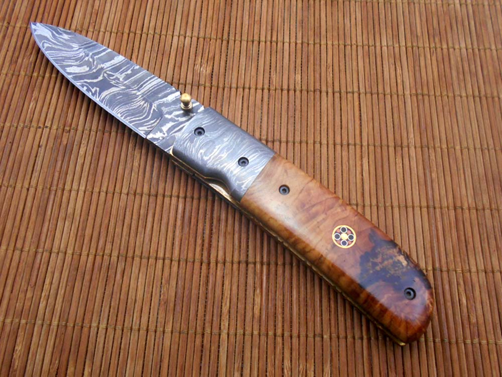 7.75" Damascus steel folding knife, liner lock, thumb knob, Cow sheath