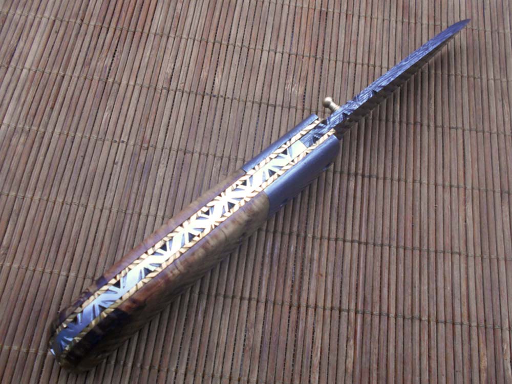 7.75" Damascus steel folding knife, liner lock, thumb knob, Cow sheath