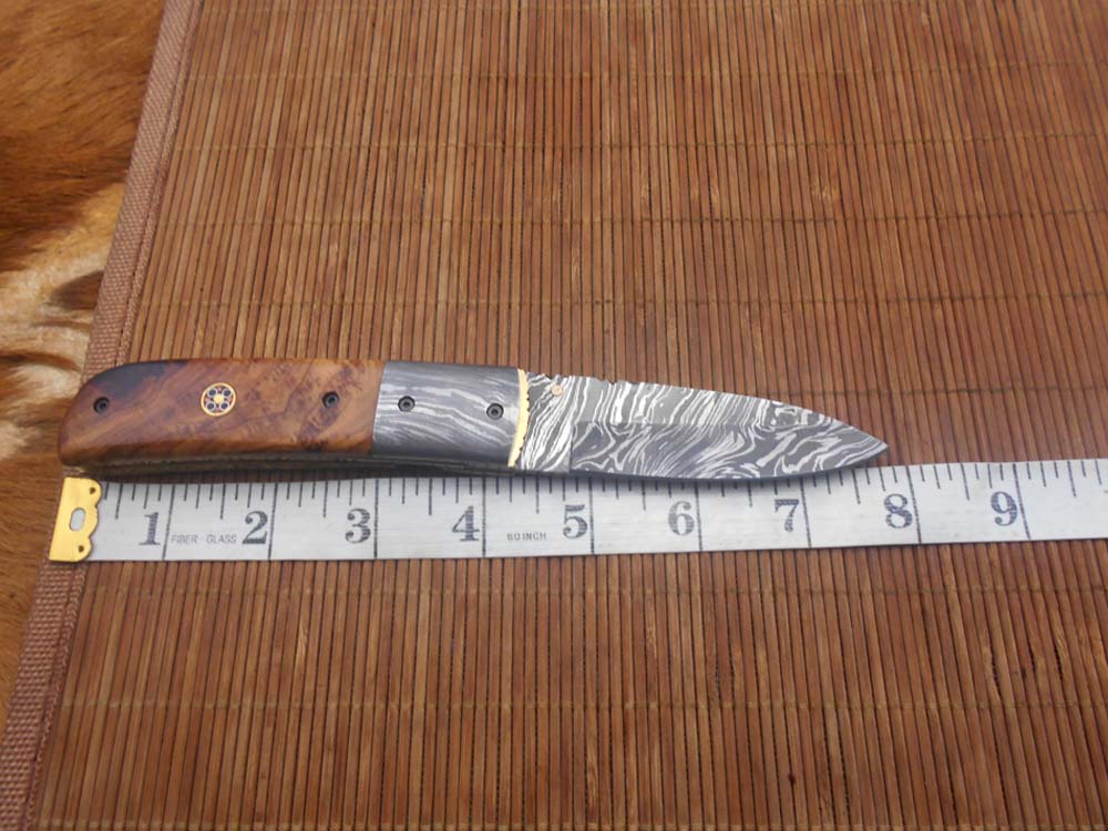 7.75" Damascus steel folding knife, liner lock, thumb knob, Cow sheath