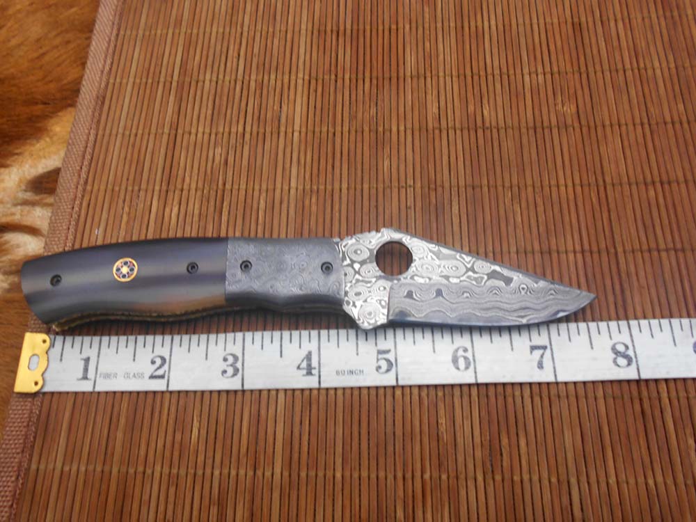 7.5" flat scale folding knife, Damascus steel blade with finger hole, Equipped with liner lock, Available in Wood & Horn scales, Leather sheath included
