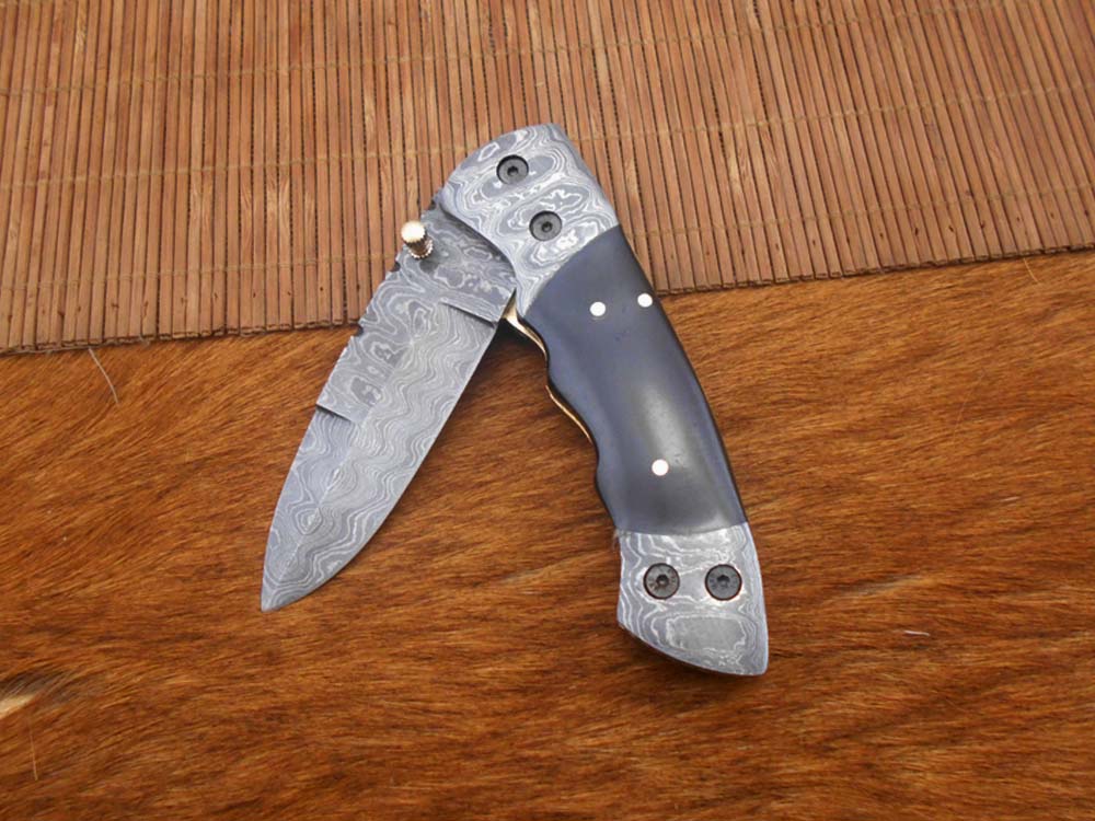 7.5" Damascus folding knife with Damascus bolster on both edges with thumb knob & liner lock equipped, Available in 4 scales, Cow hide leather sheath with belt loop included