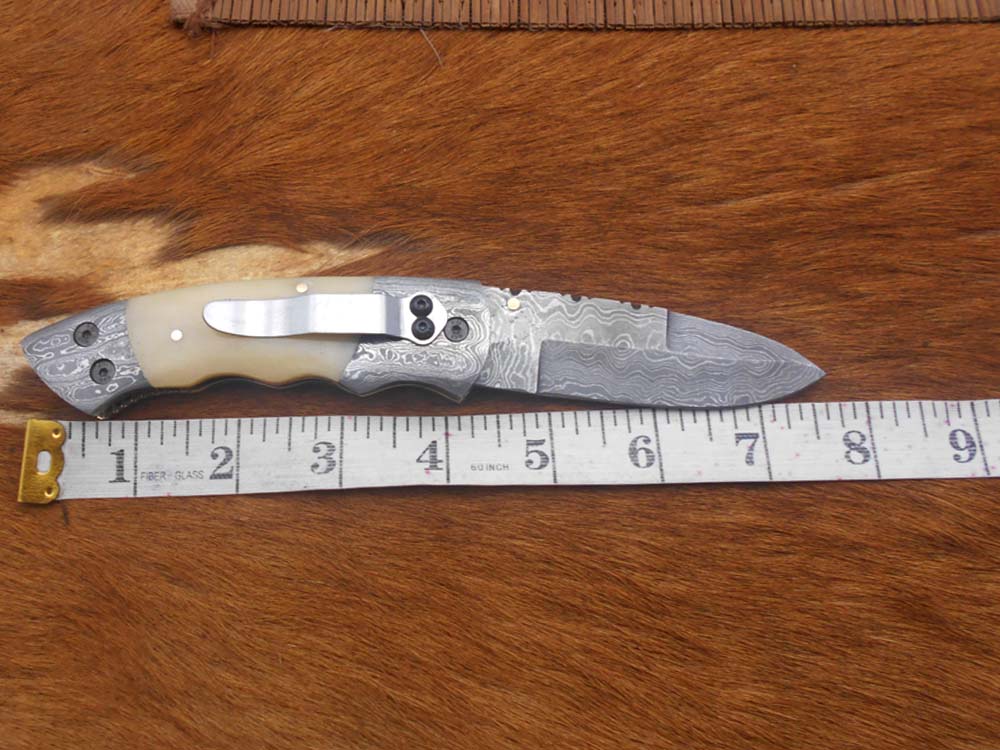 7.5" Damascus folding knife with Damascus bolster on both edges with thumb knob & liner lock equipped, Available in 4 scales, Cow hide leather sheath with belt loop included