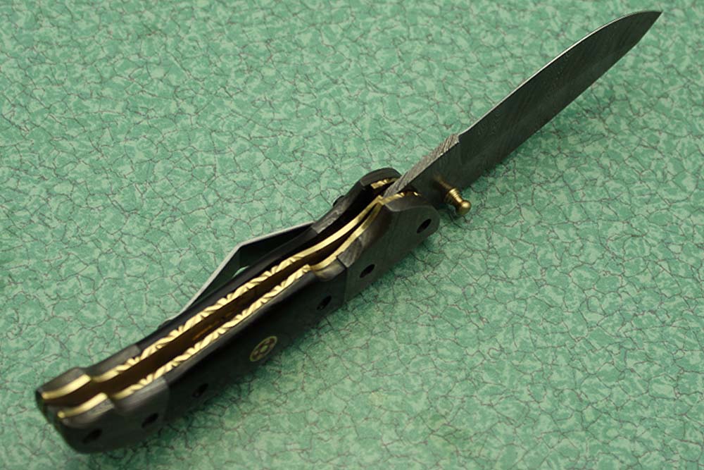 8 Inch Damascus steel folding knife, Available in Bone, Bull horn and Ram scales with Damascus bolster, Equipped with Thumb closing knob and liner lock, Cow hide Leather sheath with belt loop