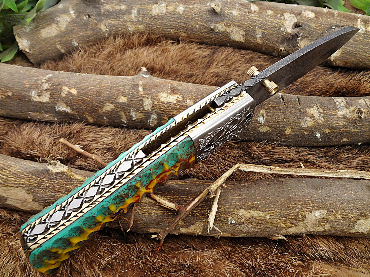 Damascus Steel Folding knife, Exotic Jigged scale in Camouflage & green combo, Engraved plant on steel bolster, Thumb knob & liner lock, Cow Leather sheath