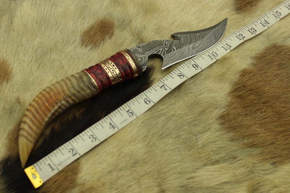 13" Long hand forged Damascus steel gut hook Skinning Knife, Custom made Round engraved jigged scale Crafted with engraved Brass spacer, Cow hide Leather sheath
