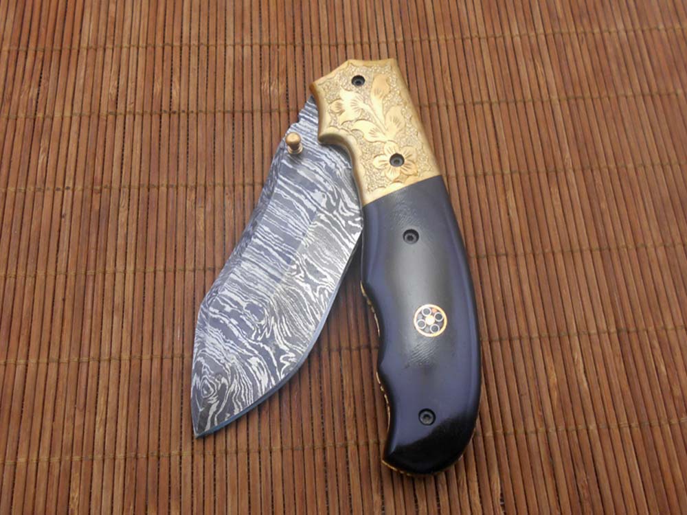 8" Damascus steel folding pocket knife with plant Engraved on brass bolster, White & black colors scale, included leather sheath