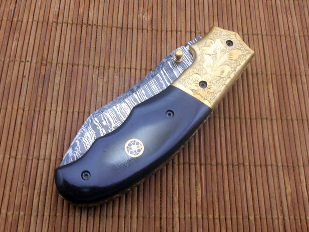 8" Damascus steel folding pocket knife with plant Engraved on brass bolster, White & black colors scale, included leather sheath