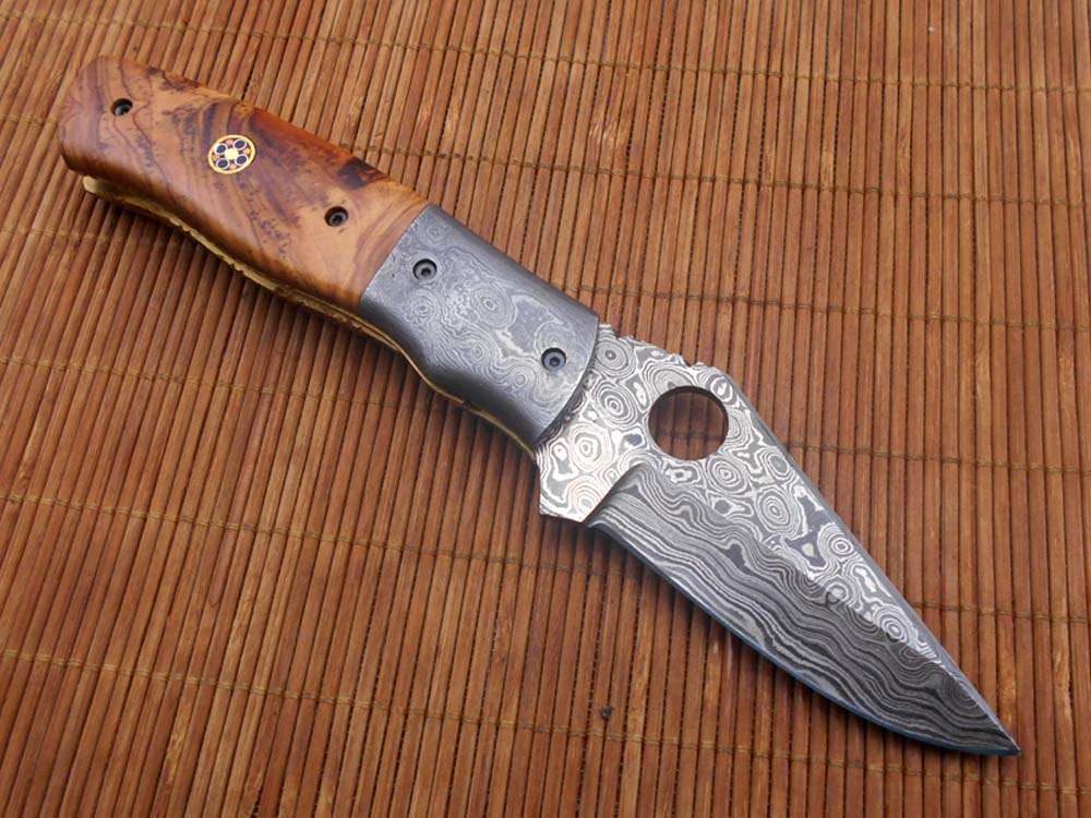 7.5" flat scale folding knife, Damascus steel blade with finger hole, Equipped with liner lock, Available in Wood & Horn scales, Leather sheath included
