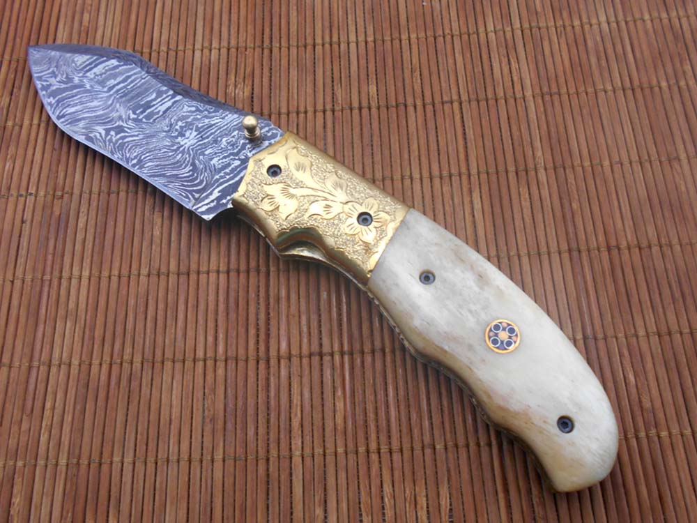 8" Damascus steel folding pocket knife with plant Engraved on brass bolster, White & black colors scale, included leather sheath