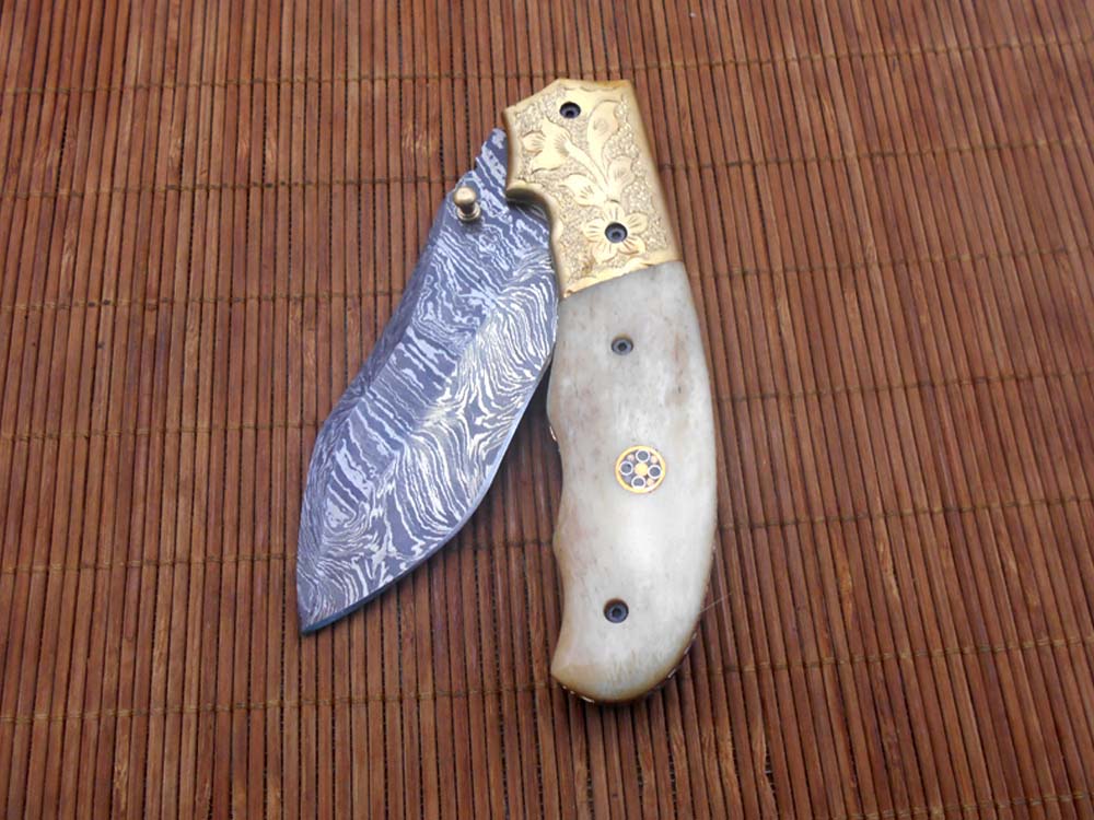 8" Damascus steel folding pocket knife with plant Engraved on brass bolster, White & black colors scale, included leather sheath