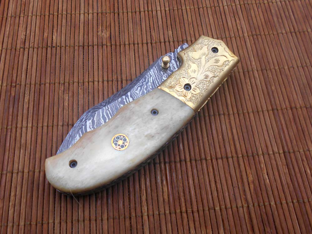 8" Damascus steel folding pocket knife with plant Engraved on brass bolster, White & black colors scale, included leather sheath