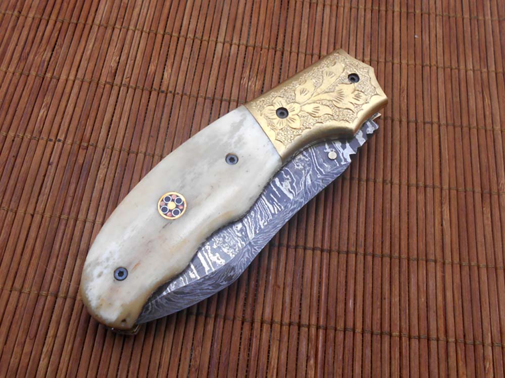 8" Damascus steel folding pocket knife with plant Engraved on brass bolster, White & black colors scale, included leather sheath