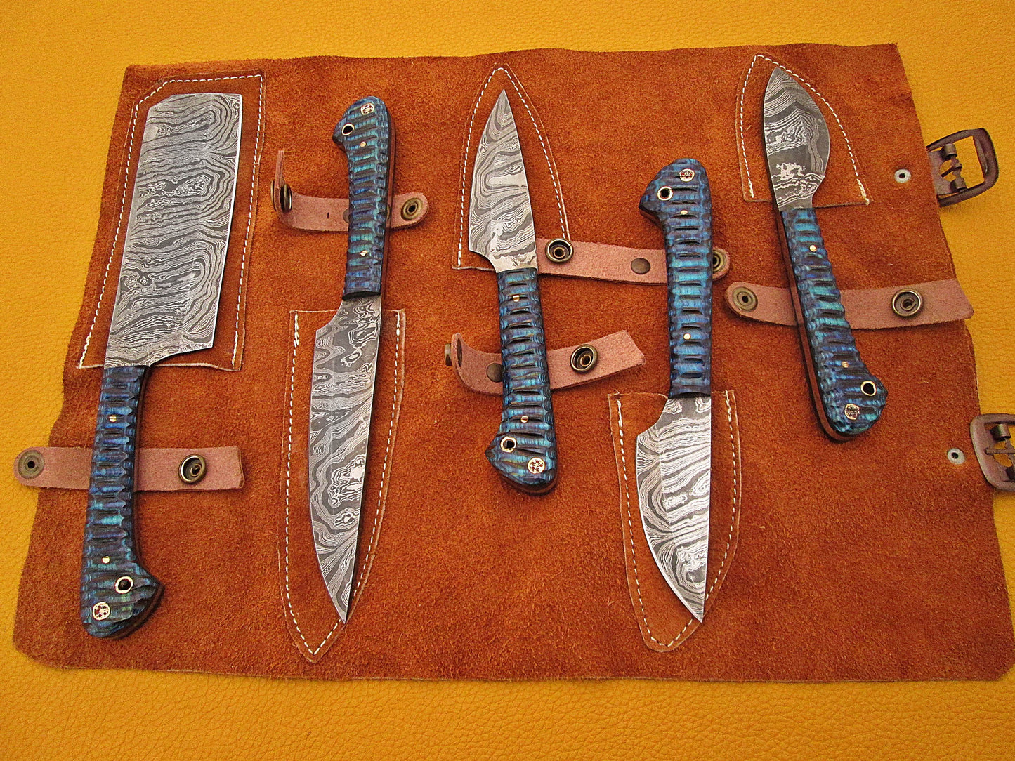 5 Pieces Damascus steel kitchen knife set includes (10.6+9.6+9.0+8.0+7.6)" knives in Blue Jigged wood scale, includes Roll able Leather suede sheath